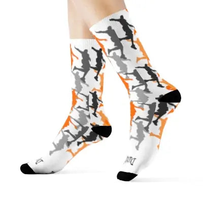 Side profile of white socks with black, grey and orange dunking silhouettes. Black heels