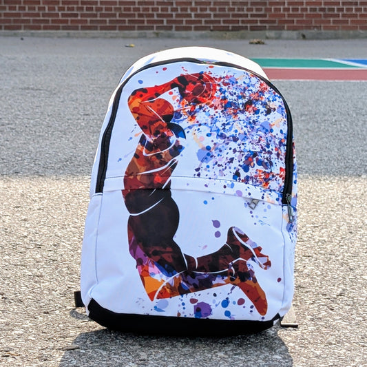 Backpack with colorful design on a pavement background