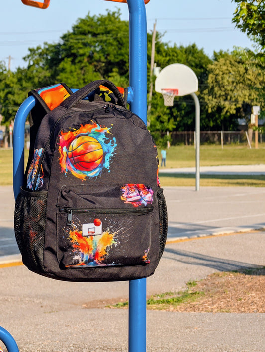 Black backpack with colorful basketball net and basketball designs.