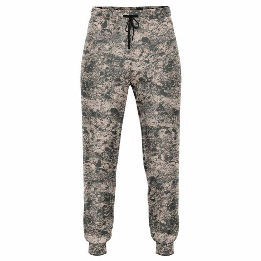 Pink joggers with dark gray mud print, pockets, and a string for waist.