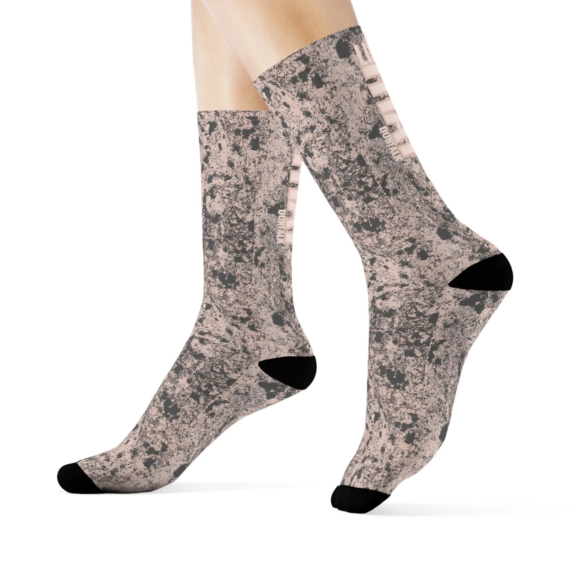 Pink socks in gray mud print with words on the back of each sock saying "Like That Duntalk" white and pink