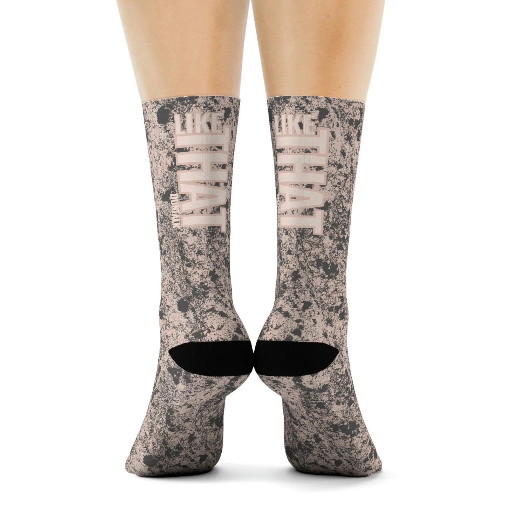 Pink socks in gray mud print with words on the back of each sock saying "Like That Duntalk" white and pink