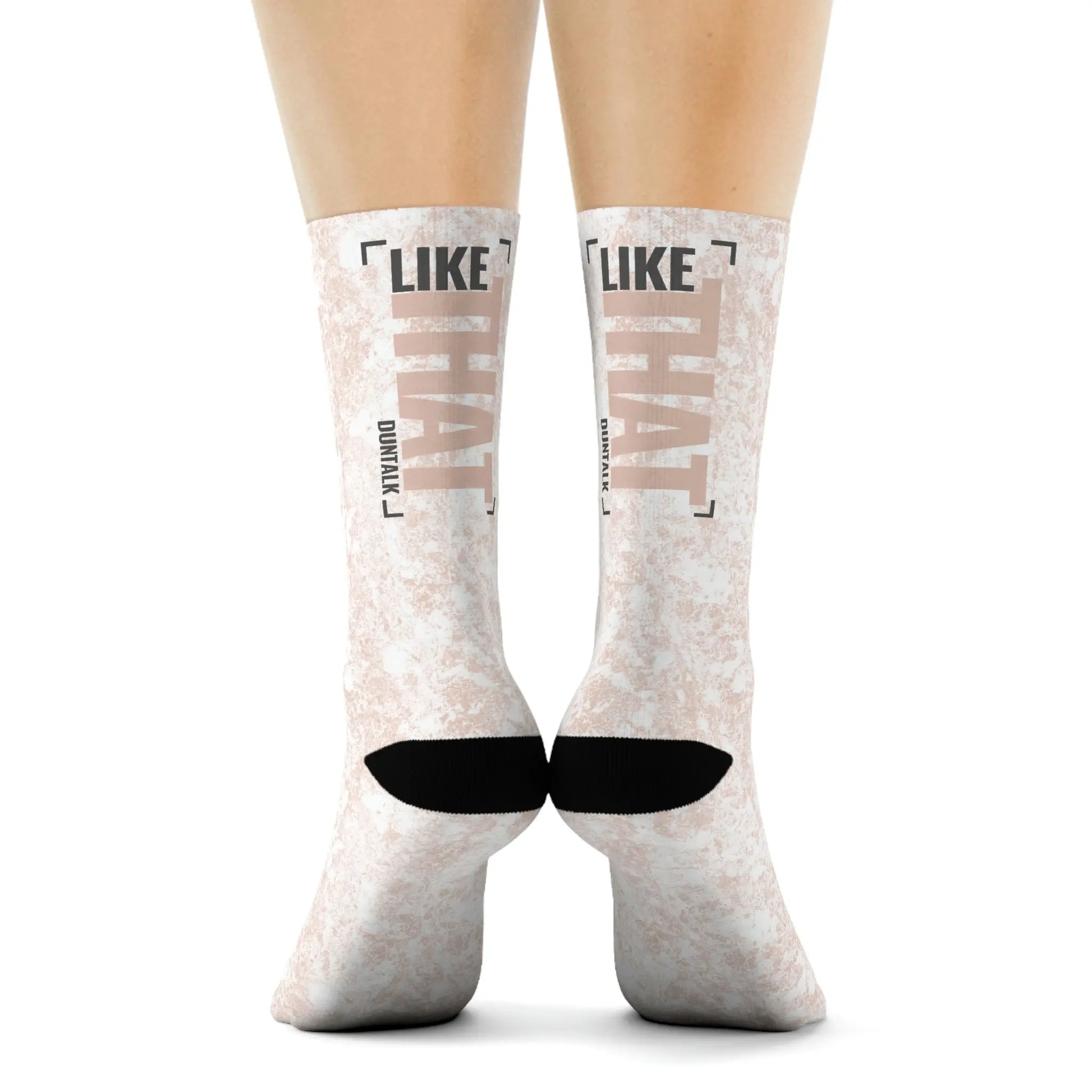 White socks in pink mud print with words on the back of each sock saying "Like That Duntalk" gray and pink